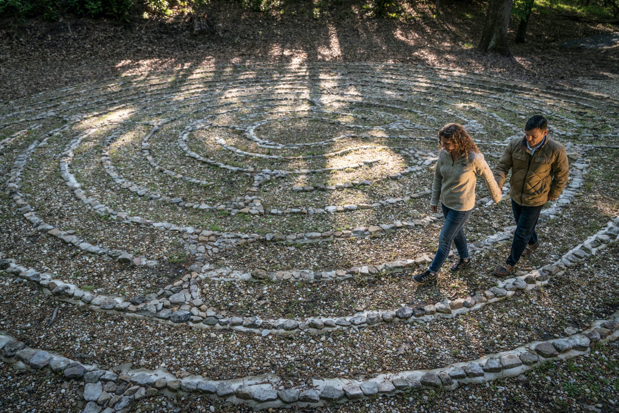 Couple walking labyrinth holding hands