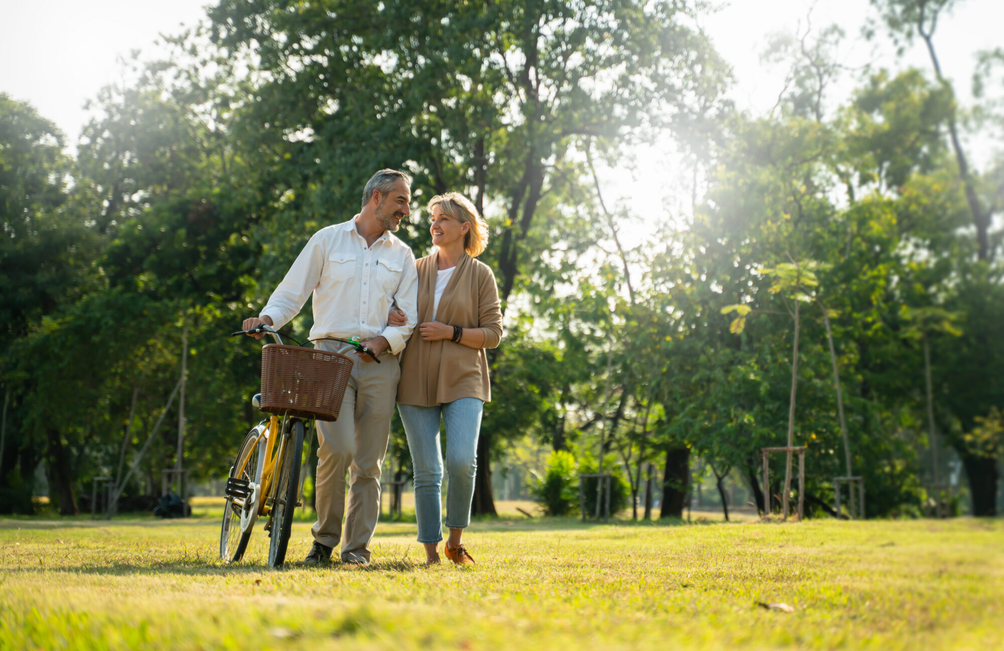 older married couple riding their bike, one of our spring date ideas