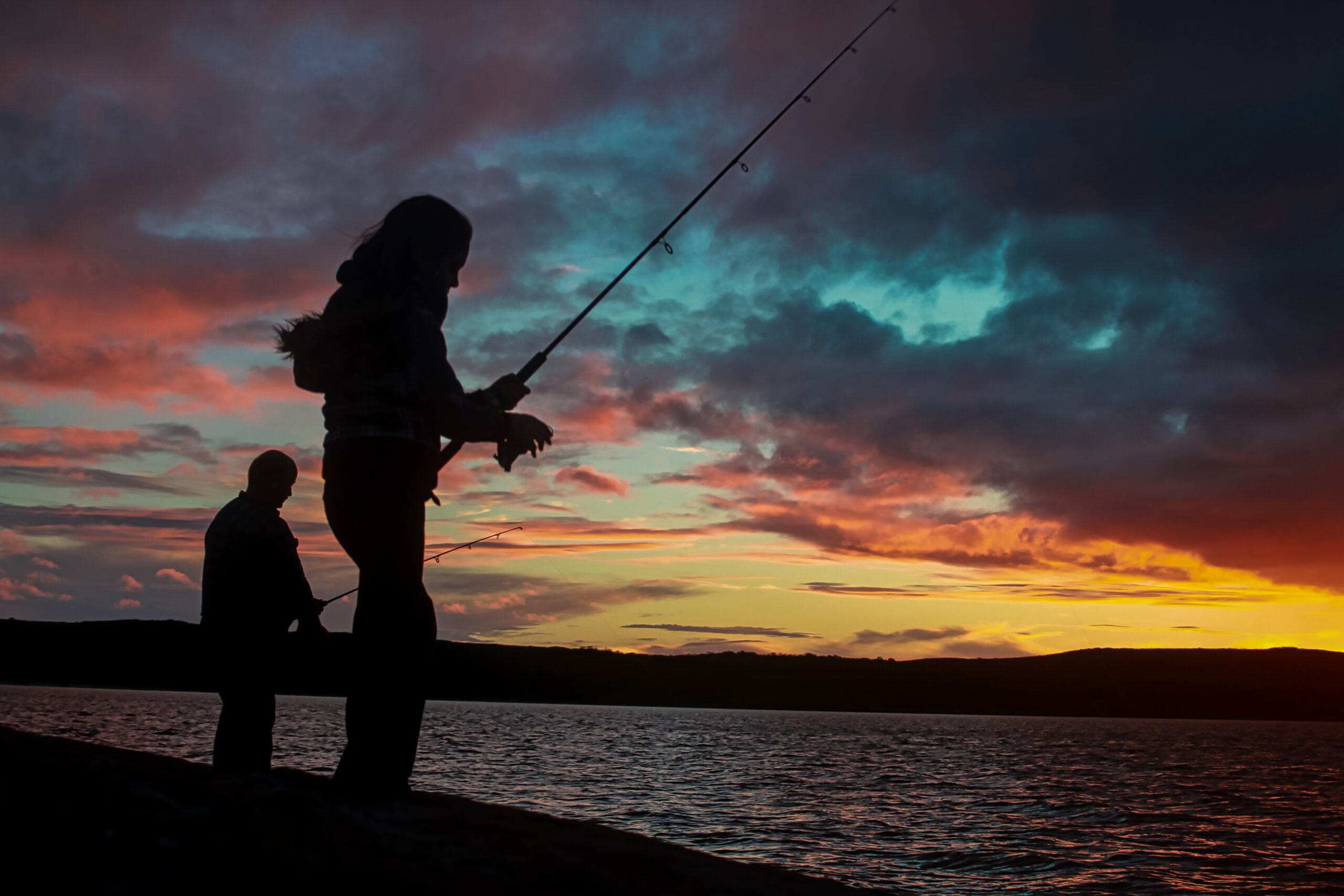 young married couple fishing at night one of our summer date ideas