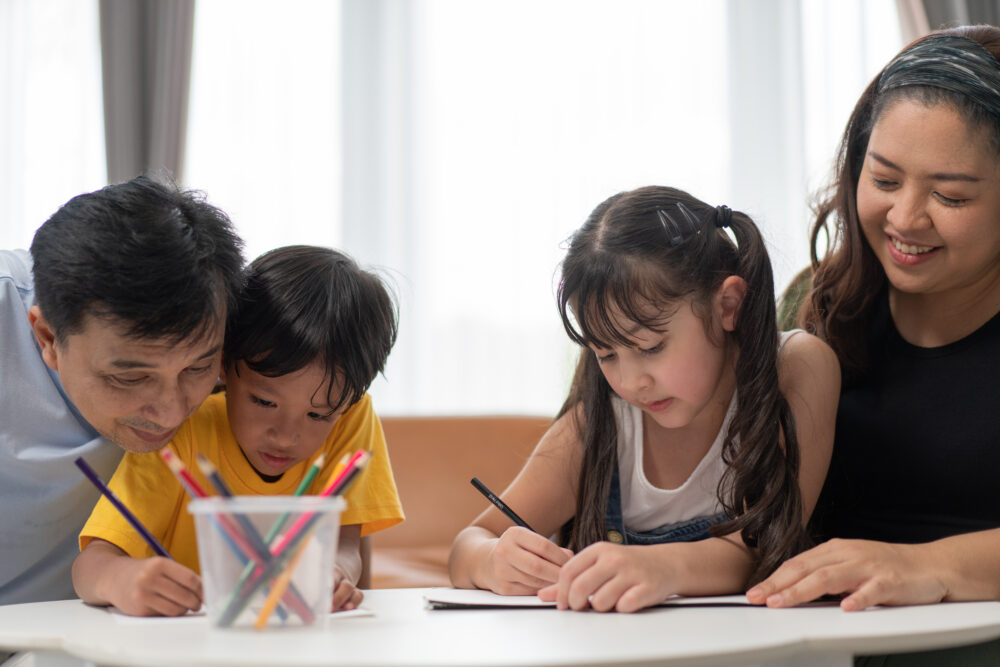 Married couple with children preparing for the upcoming school year and how to be successful; they are helping their kids wi