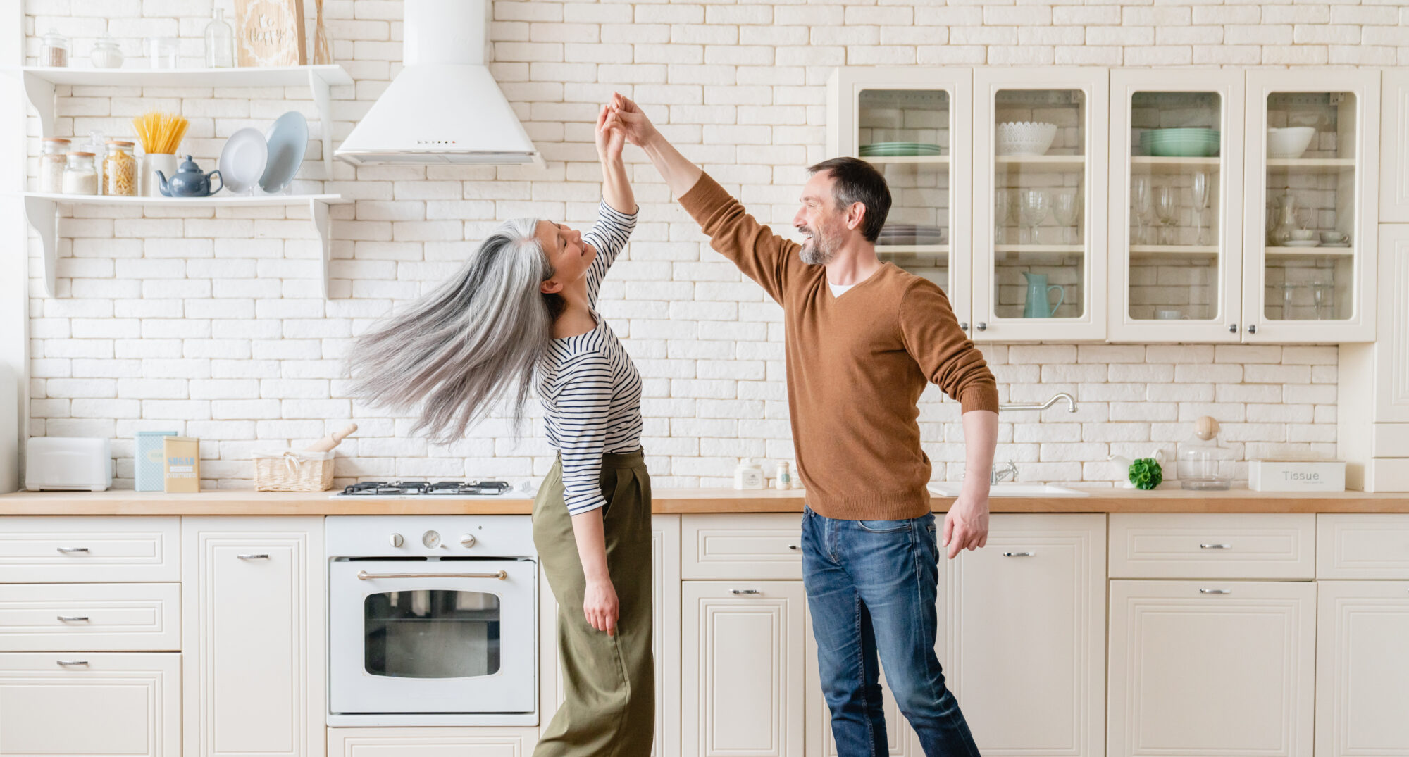 Middle-aged married couple dancing together after taking a dance class, one of their alphabet dating ideas