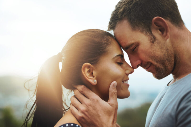 Young married husband and wife sharing an intimate moment together