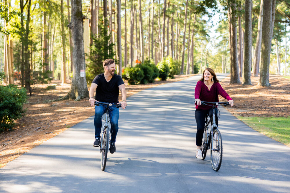 Middle aged married couple riding a bike during a Christian marriage retreat at WinShape Retreat