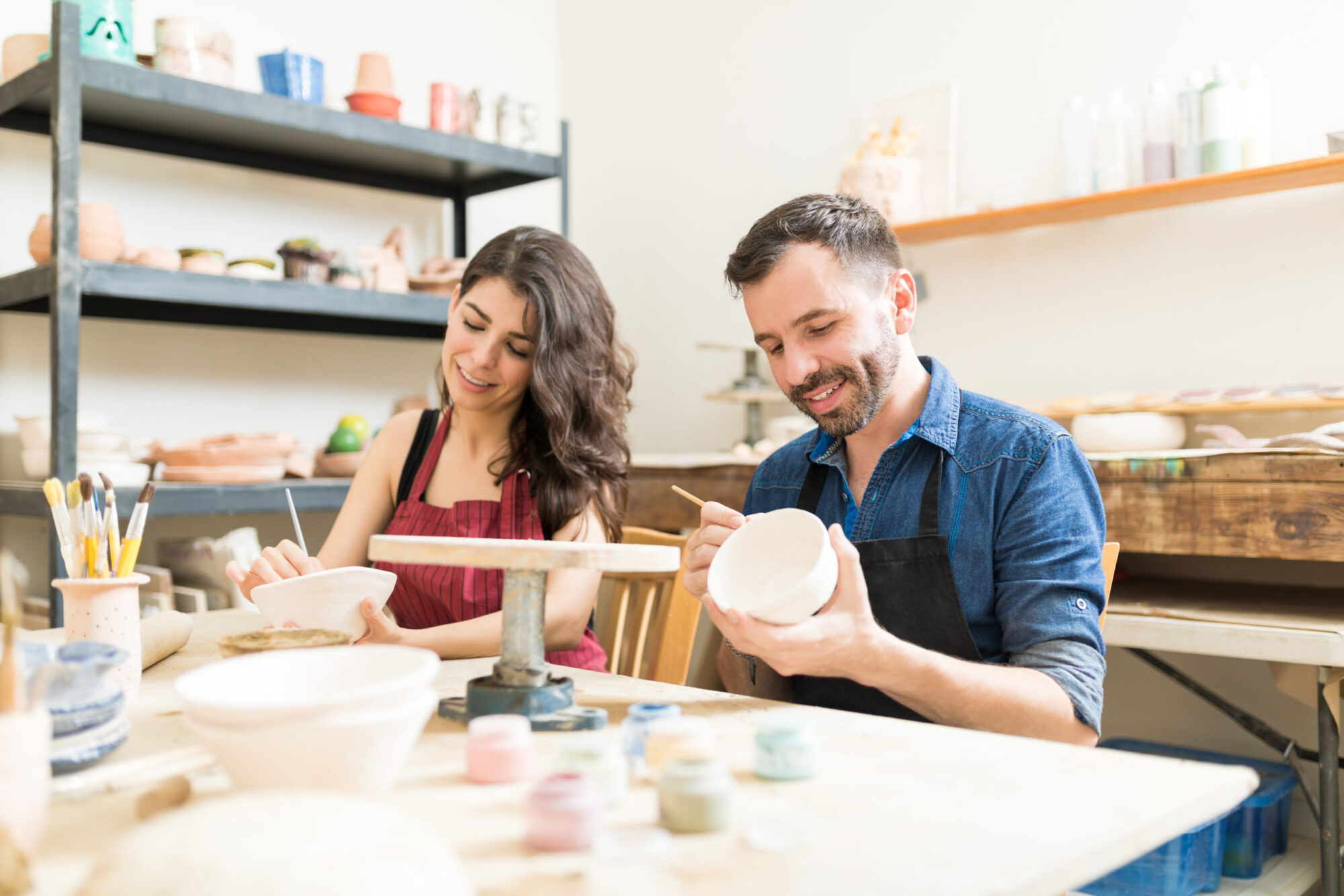 Married couple enjoying a painting class experience together and making memories rather than acquiring material items