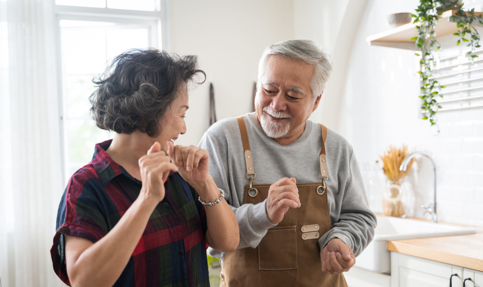 An older married couple celebrating each other practicing teamwork in marriage
