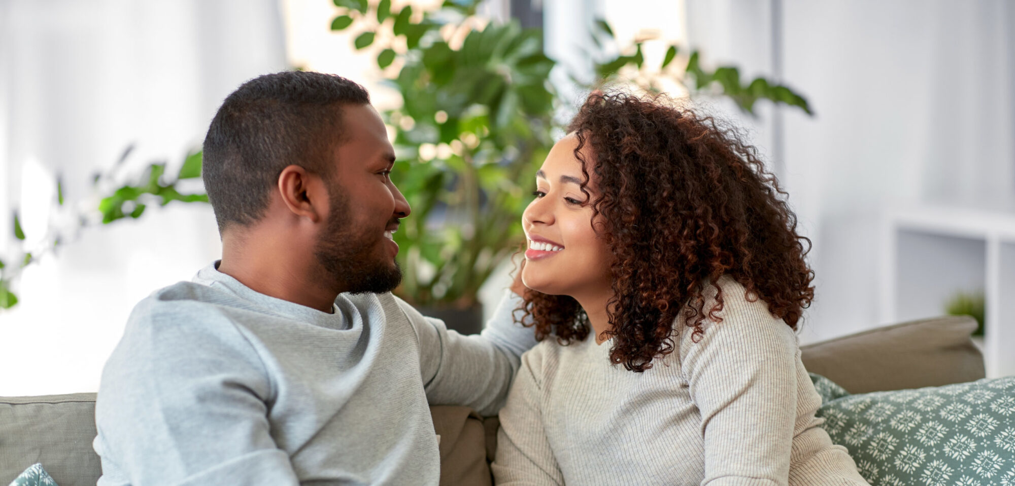 Young married couple searching for what to talk about with your spouse to reconnect and using some of our advice for conversation prompts