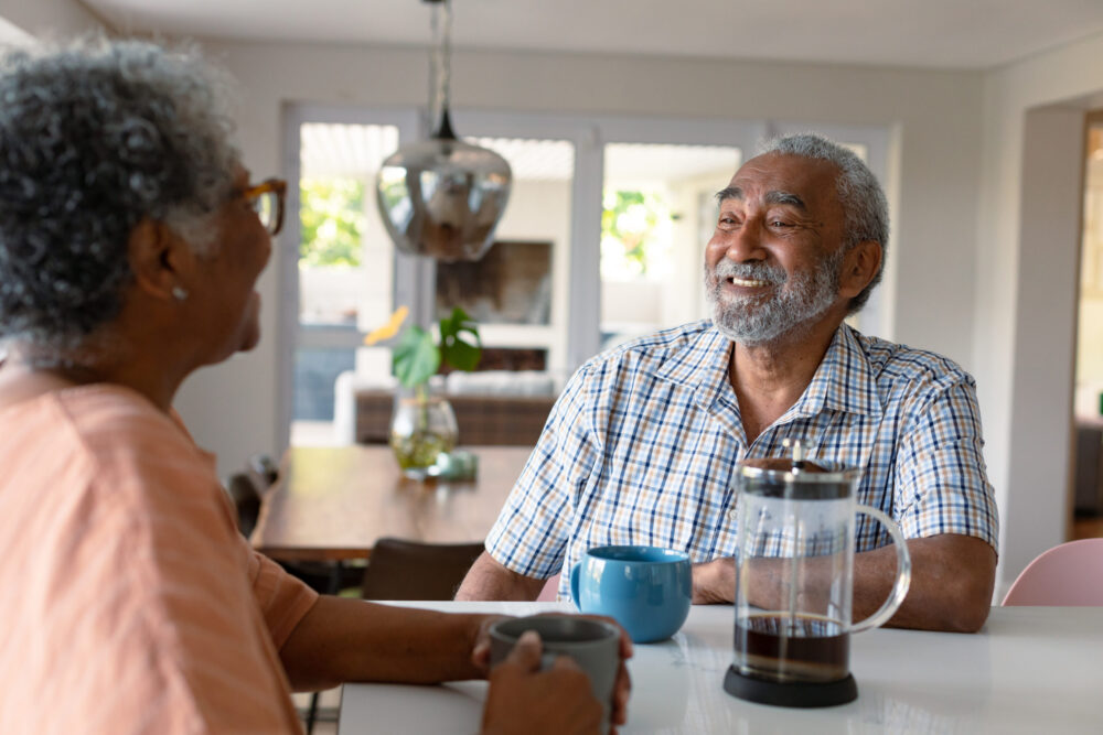 Older married couple looking for how to reconnect with your spouse, so they're sharing intentional conversation with one another