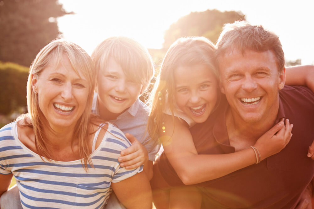 Middle-aged married couple with their two children, having conversation discovering what is the purpose of marriage