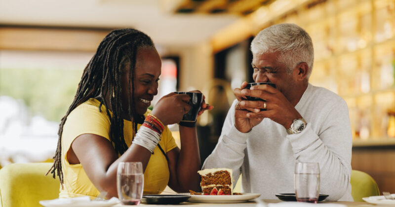 Older married couple enjoying dessert and talking; they're working on implementing our tips for how to communicate better with your spouse