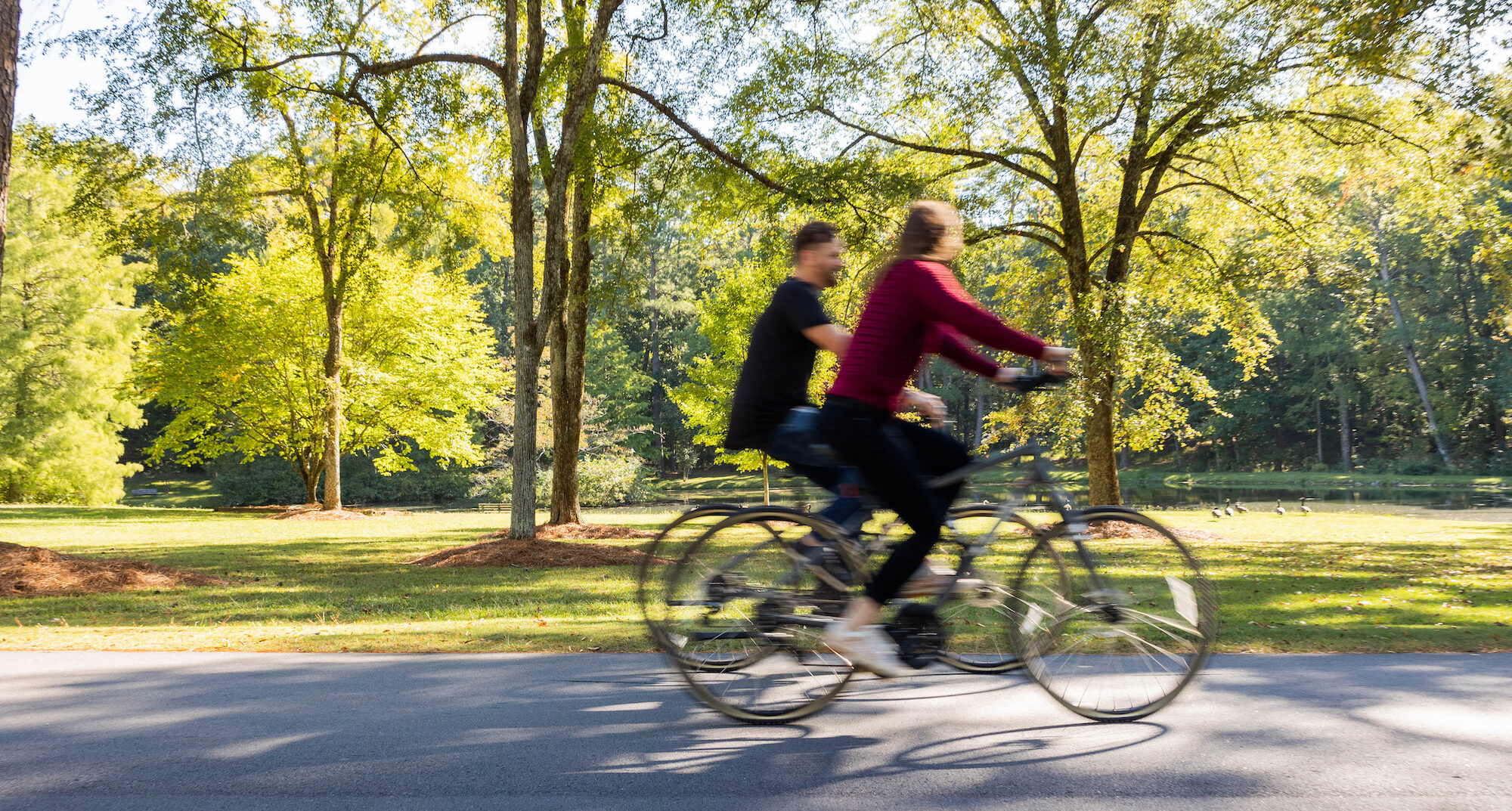 a blurred image of a married couple riding bikes at winshape retreat