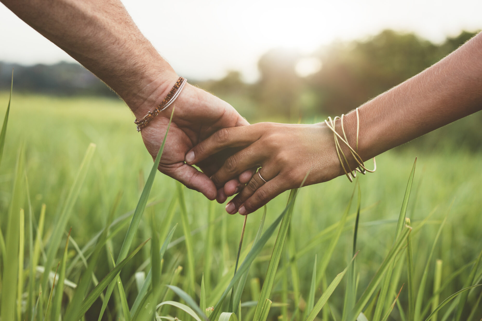 a couple holding hands; they're focusing on being intentional about prayers to pray for your spouse