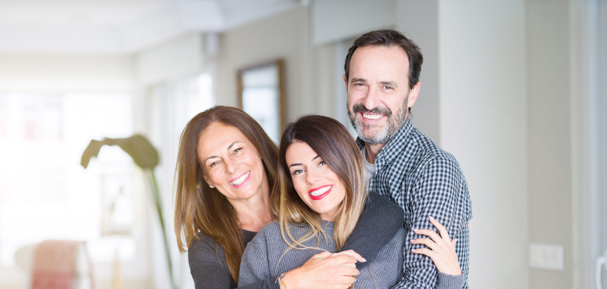 Older married couple with their adult daughter learning how to navigate the season of parenting adult children
