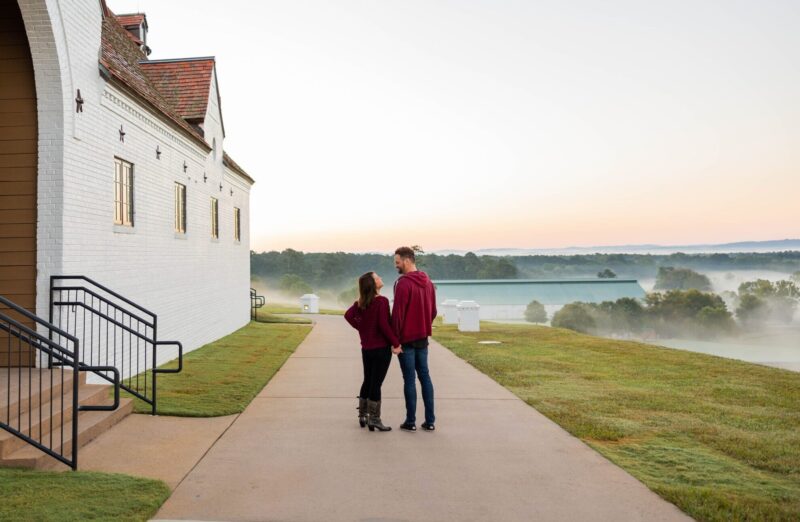 an image of a married couple walking at winshape retreat on a foggy day