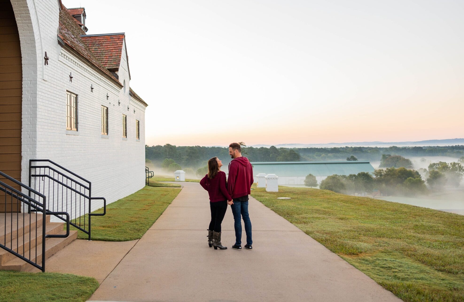 an image of a married couple walking at winshape retreat on a foggy day