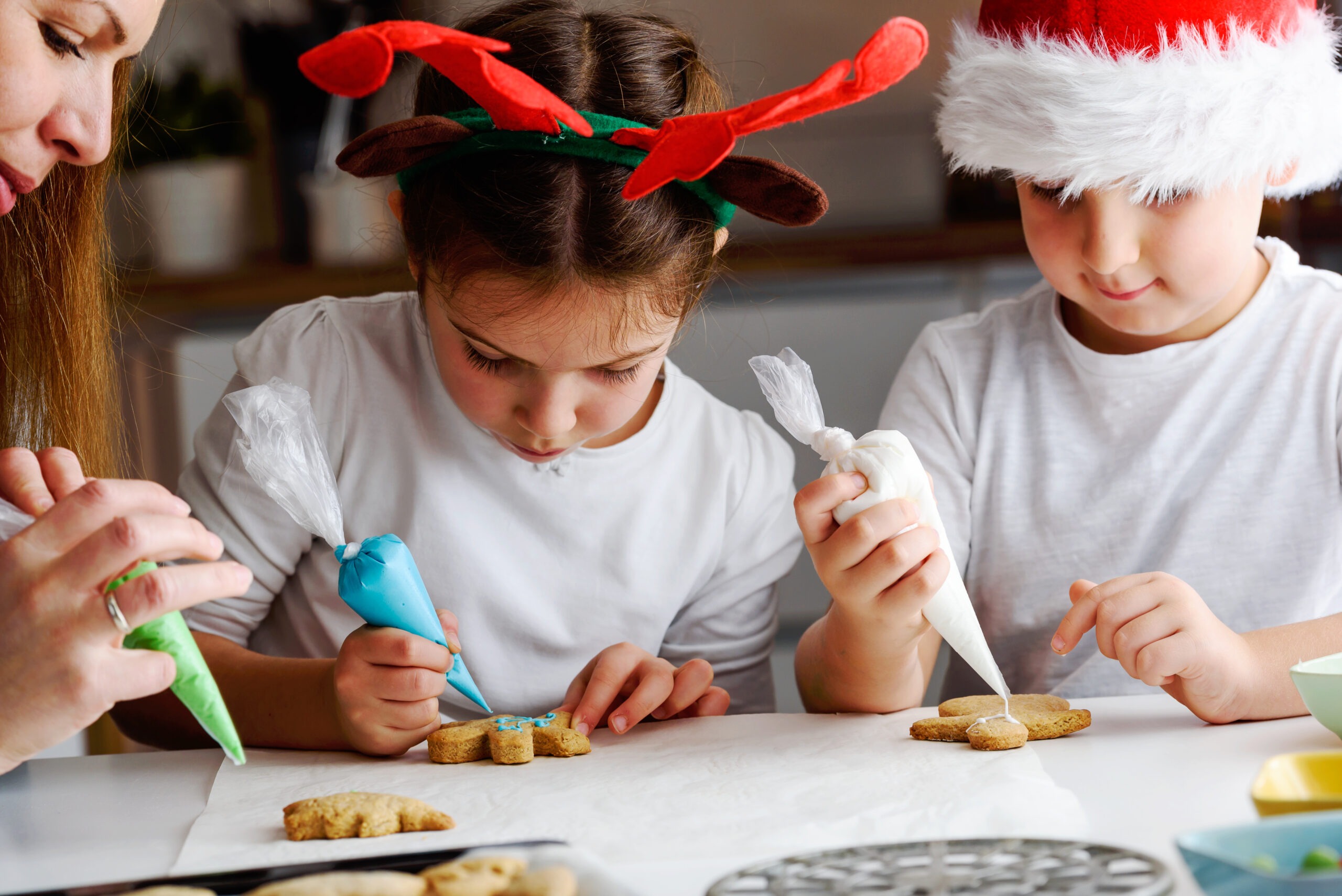 Family participating in one of our 12 days of christmas tradition ideas by decorating christmas cookies together