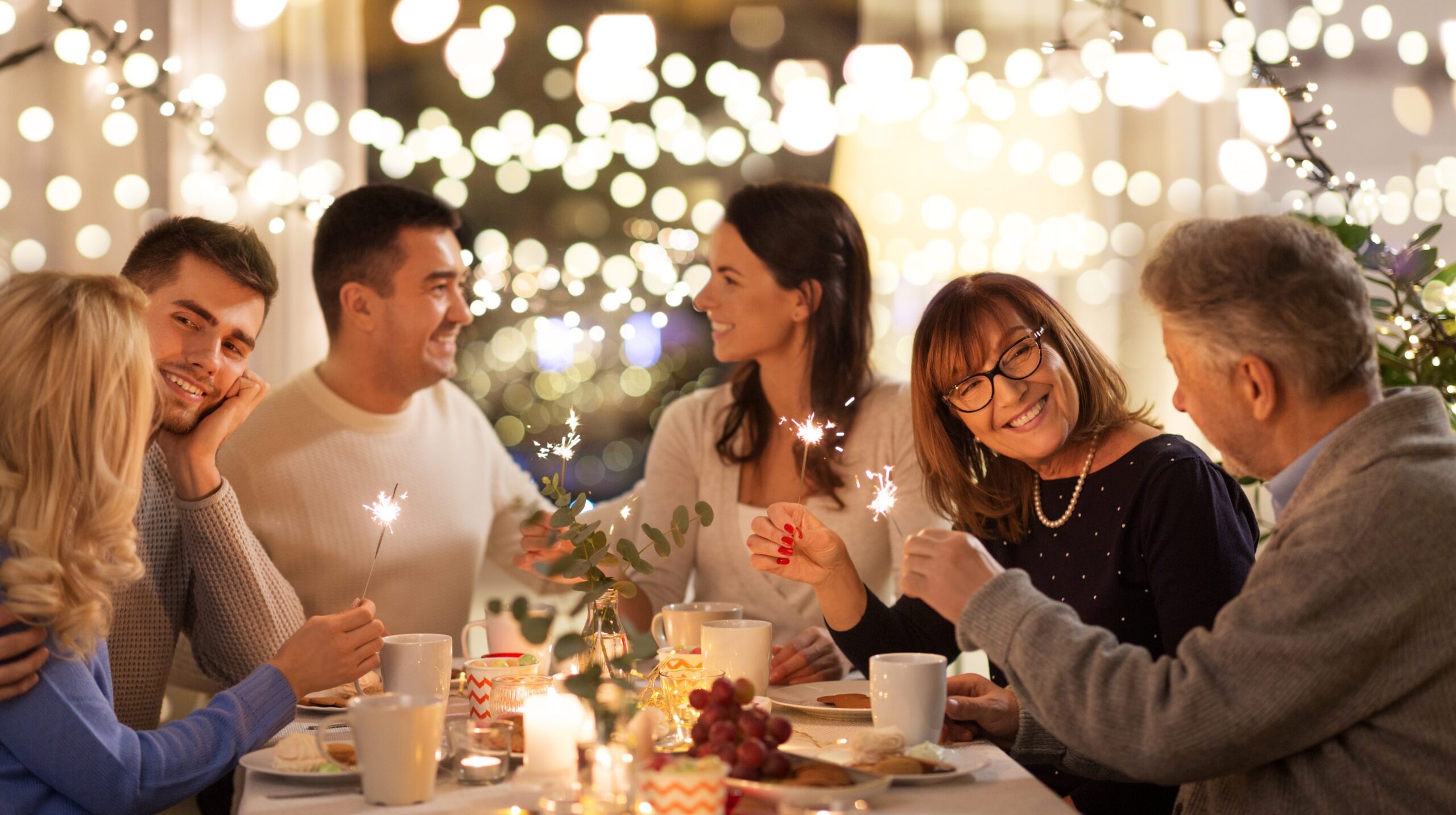 a couple celebrating the holidays with their family early since they won't be home for christmas