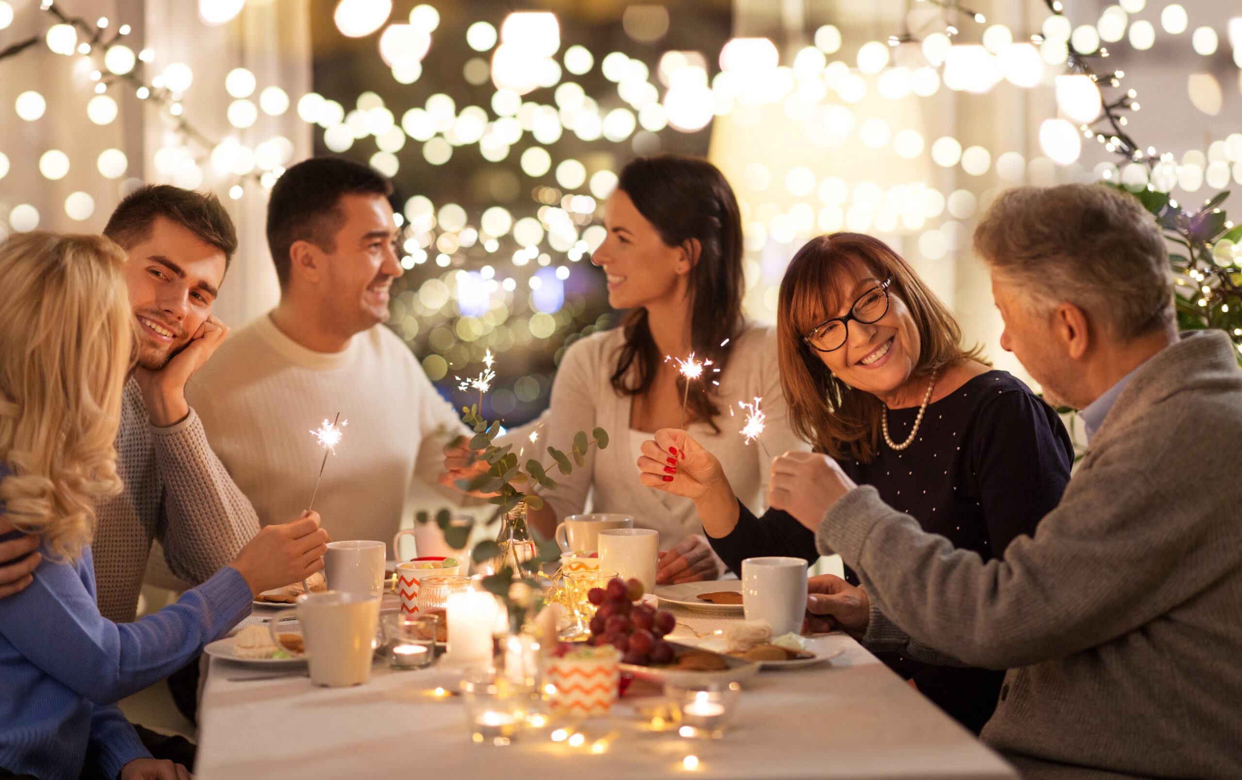 a couple celebrating the holidays with their family early since they won't be home for christmas