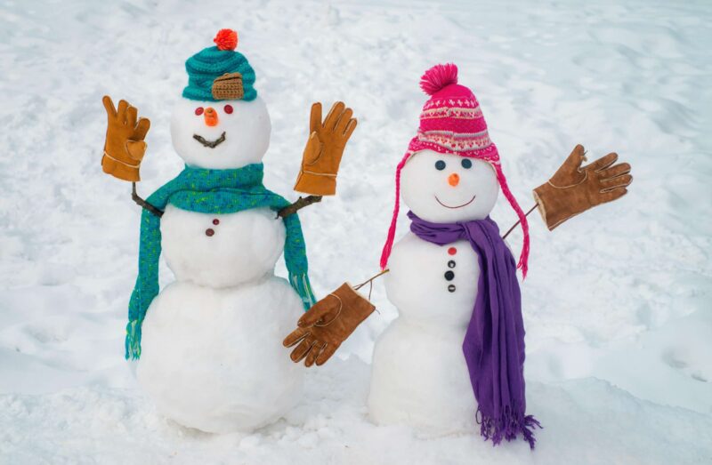 Boy and girl snowmen aka a snow couple, building snowmen is one of our winter date ideas
