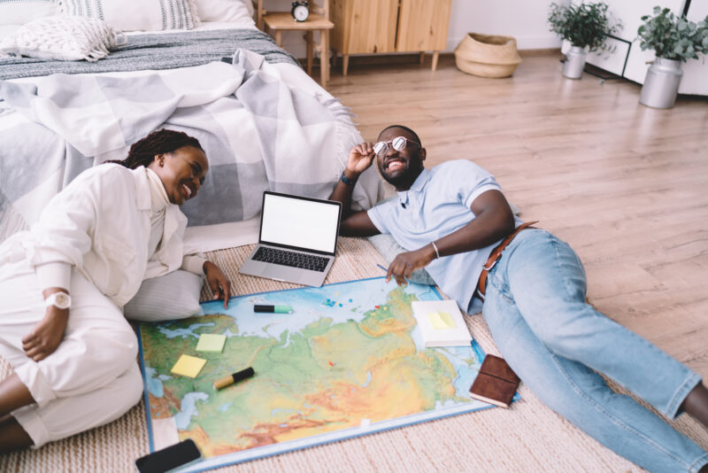 Young married couple planning a trip together, one of our winter date ideas