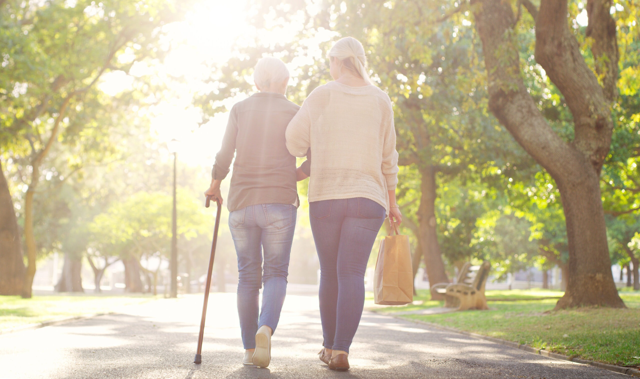 Middle aged woman going on a walk with her mom, one of our ideas for things to do with elderly parents