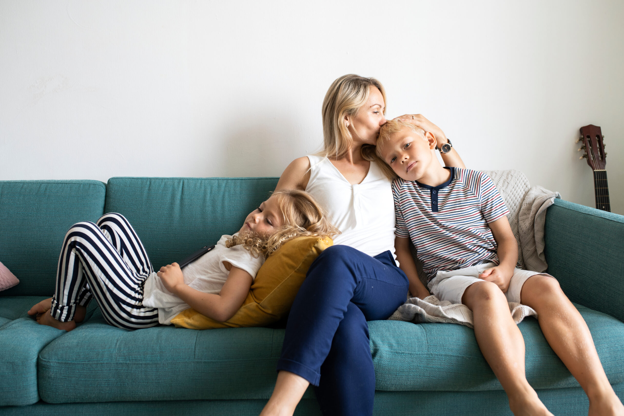 mother, daughter, and son, sitting together enjoying a sweet moment; husband is seeking out top 10 mother's day gift ideas for his wife