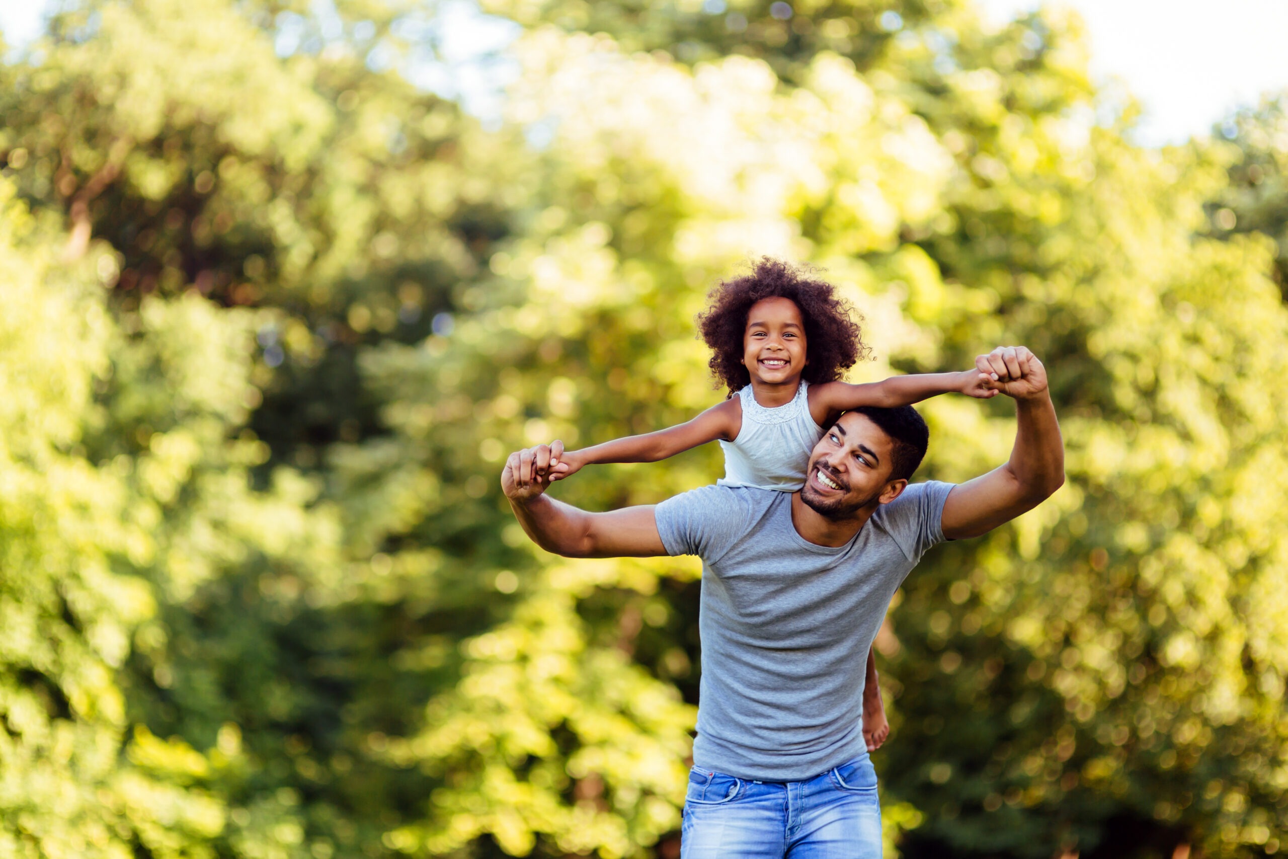 father and daughter are playing together enjoying a sweet moment; wife is seeking out father's day gift ideas for her husband