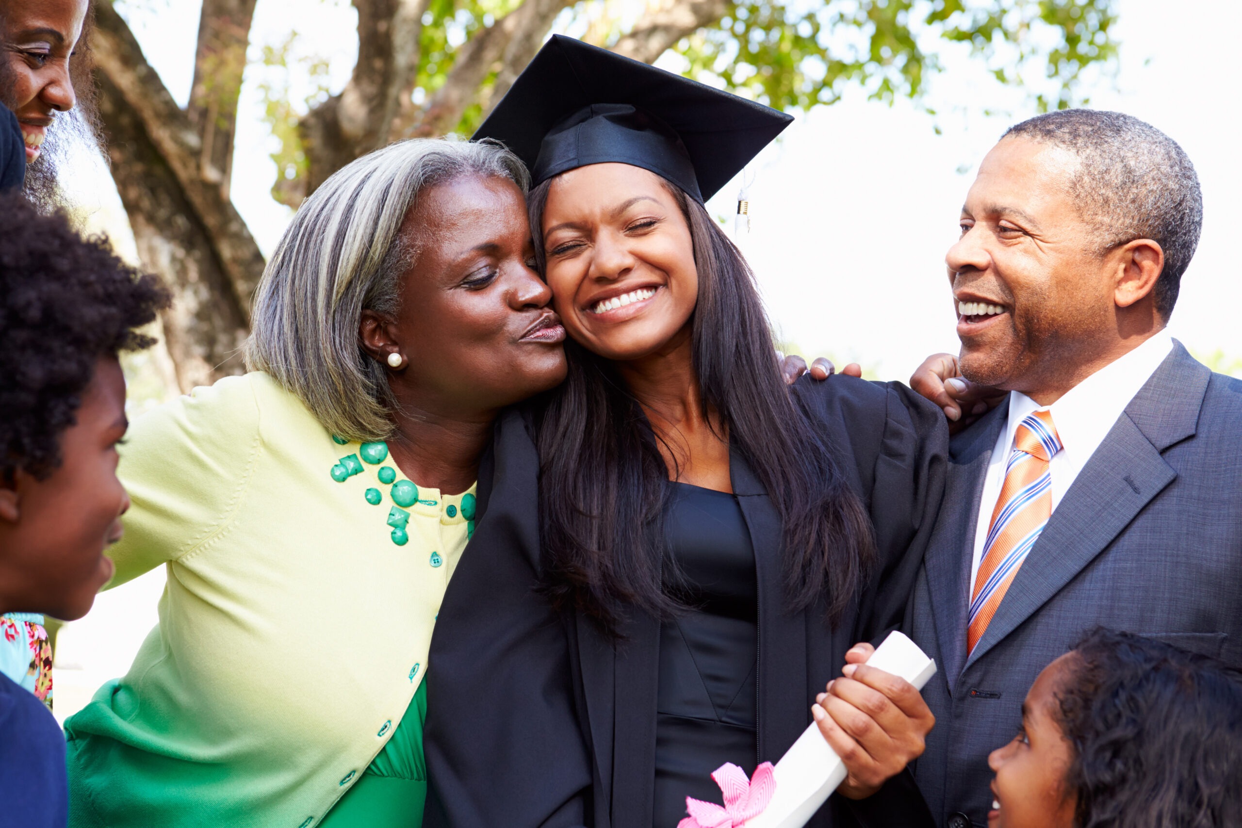high school graduate hugging her mom and dad, anticipating how to prepare for college