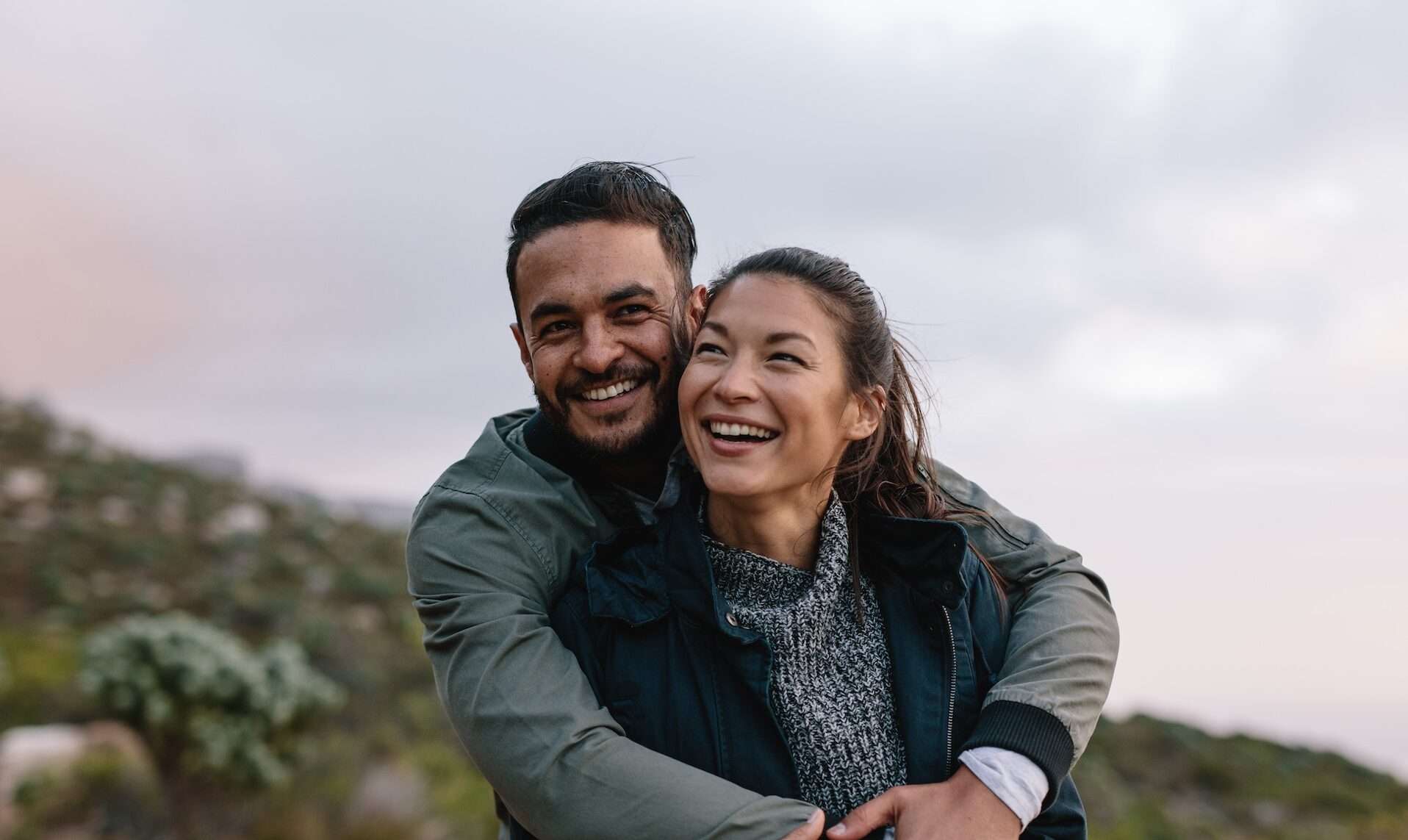 Couple in love embracing in nature. Romantic young man and woman on country trail.