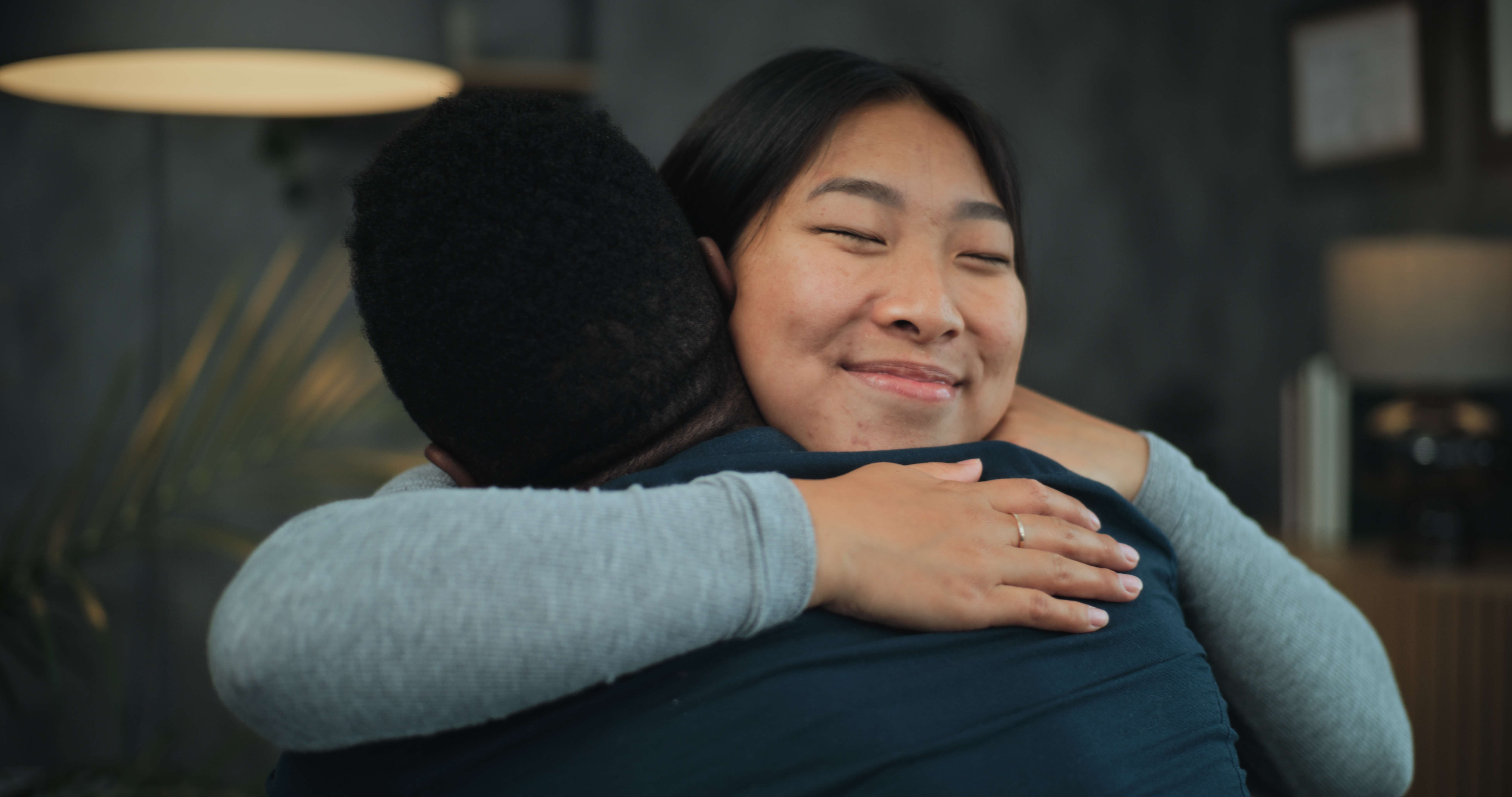 Couple reconnecting after conflict, holding hands, using one of our conflict resolution strategies