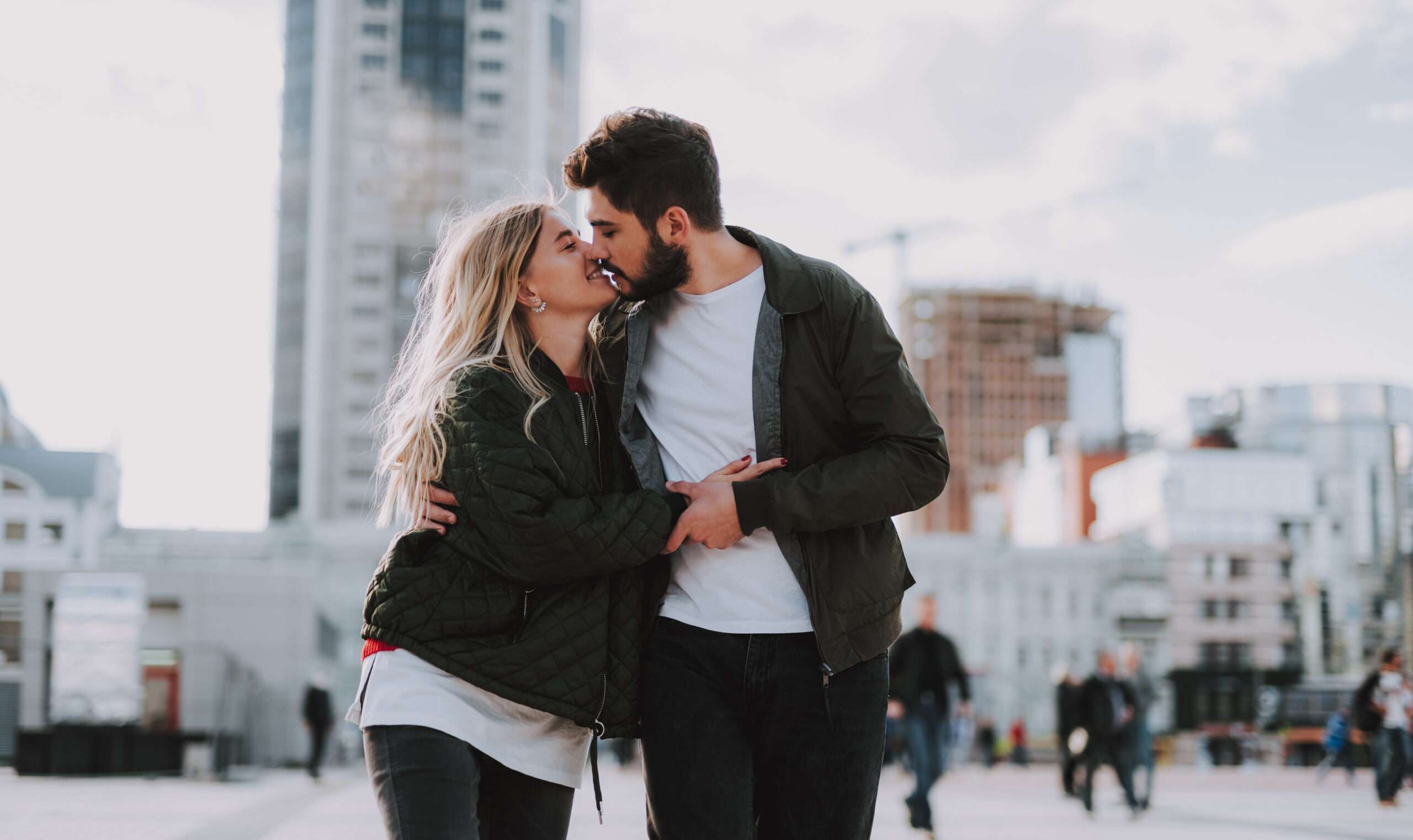 Young married couple hugging and kissing showing signs of physical intimacy one of the different types of intimacy